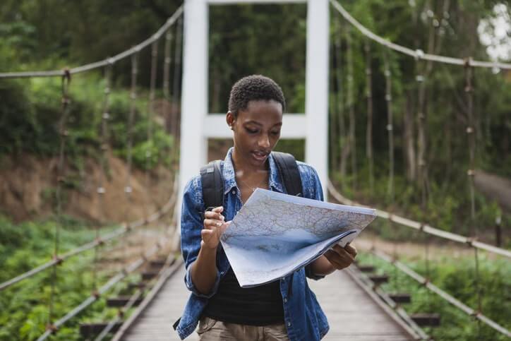 An Image of a Woman Moving Around With a Map in Hand