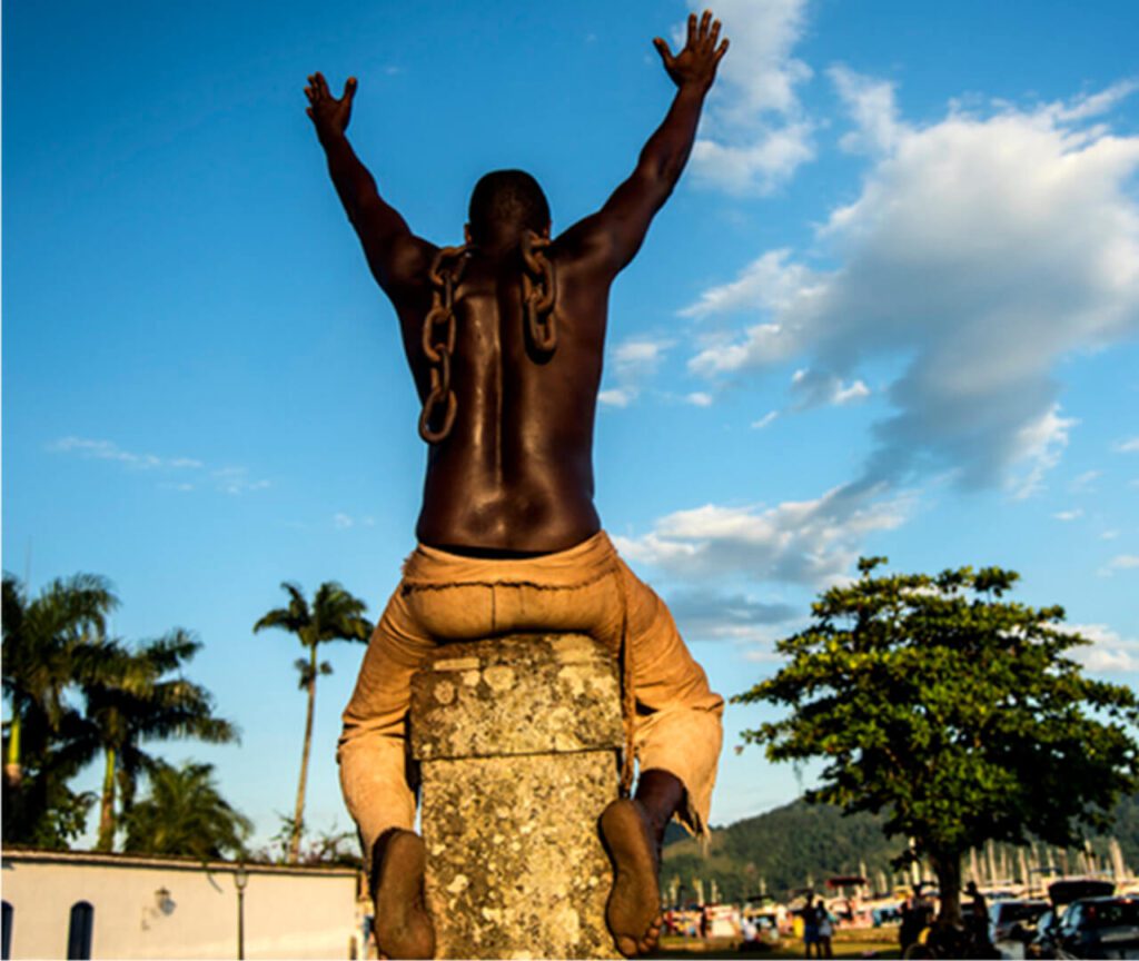 man on stone with chains