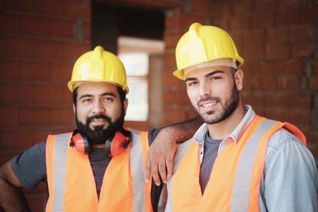 People working in construction site portrait of happy men