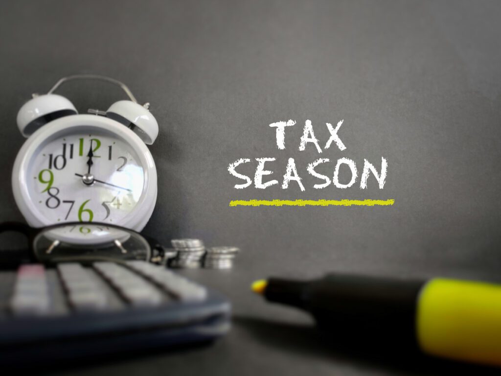 Tax season text in vintage background. Stock photo.